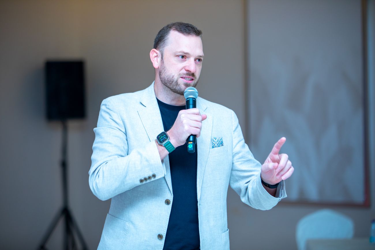 Alex Collins delivering a keynote at a company town hall